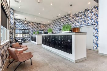 a lobby with chairs and a counter filled with bottles of wine at The Virginia, Texas, 78155